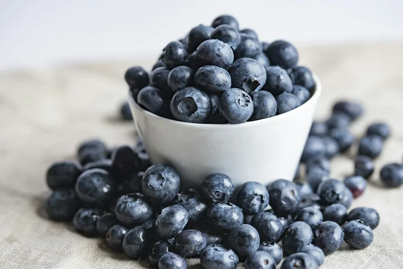 Fresh dark blueberries and mixed berries in a bowl
